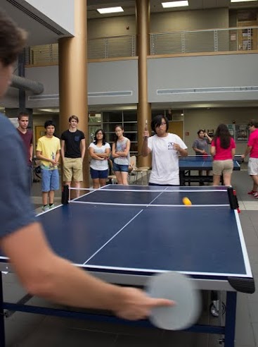 MSMS senior and Co-President of the Ping Pong Club, Meilun Zhou, plays against his opponent at the Ping Pong tournament. 