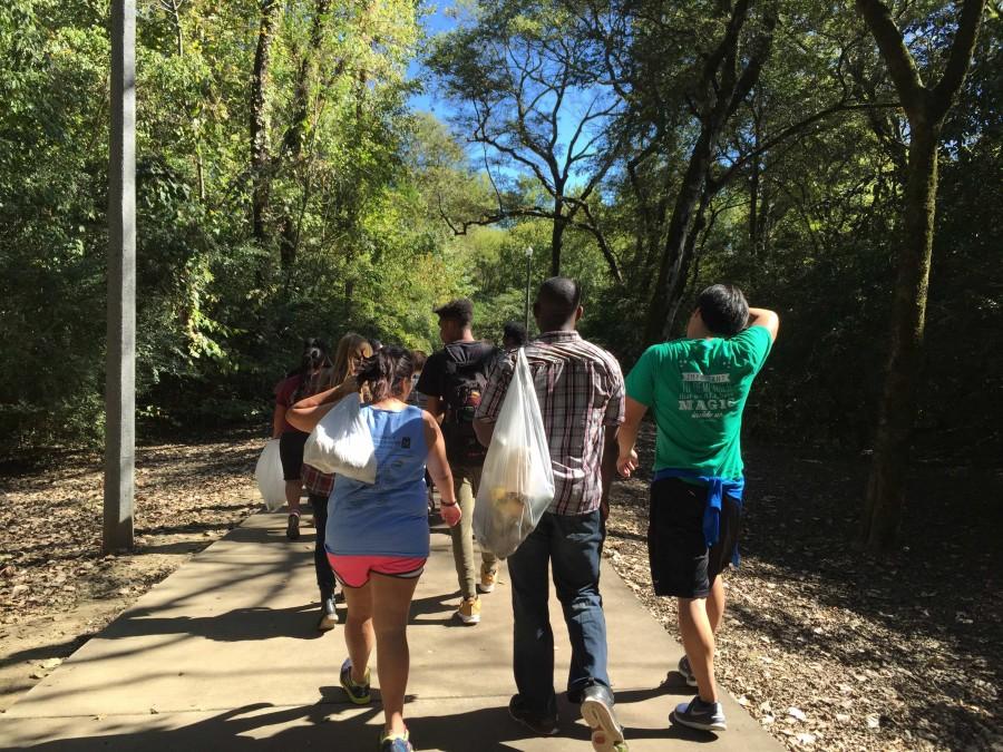 (From left to right) Bianca Martinez, Shamarcus Doty, and Allen Lin help make the Riverwalk a cleaner place.