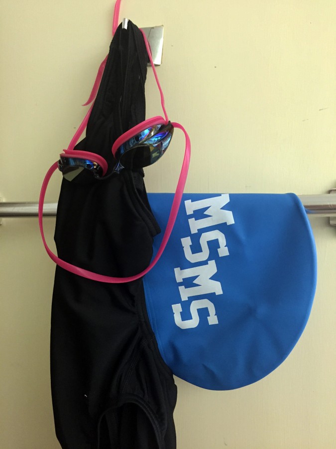 Angie Harris swim suit, cap, and goggles used at each meet.