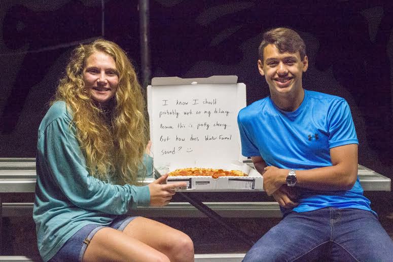 Kobe Van Someren (right) uses pizza to ask Hannah Houston (left) to Winter Formal.  Other students are beginning to ask their dates and help plan for decorations.