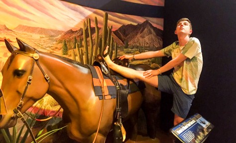 Connor McNamee with his leg on a fake horse. 