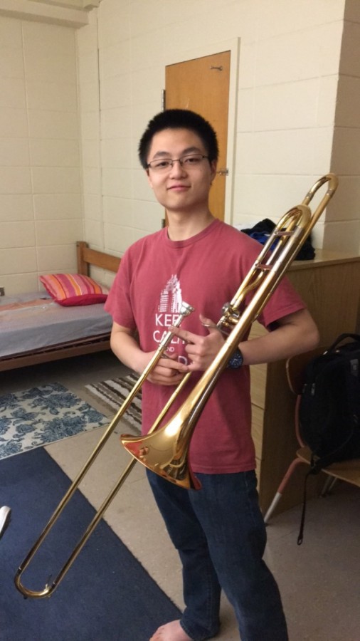Junior Andy Zhao posing with his trombone.