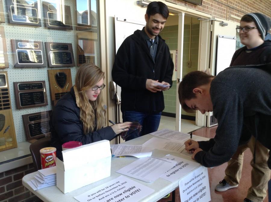 Abby Perry and Jake Bozlee of the Young Democrats club help students register to vote.
