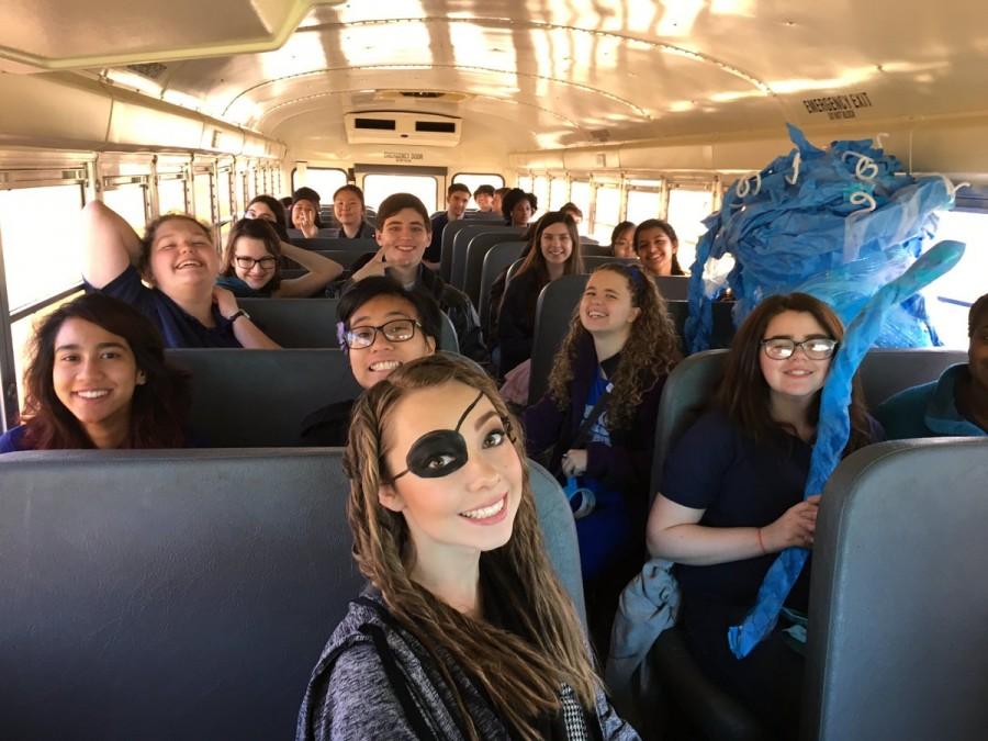 Latin students in various stages of costume dress on the bus to MSU.