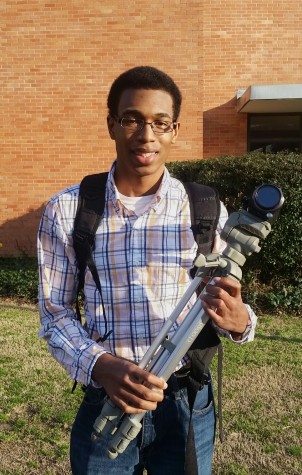Hamari Brown holding his trusty camcorder and tripod