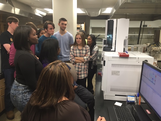 Analytical chemistry students gather around MSUs lab equipment.