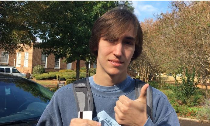 Dustin Dunaway gives a thumbs-up after finally turning in his research paper.
