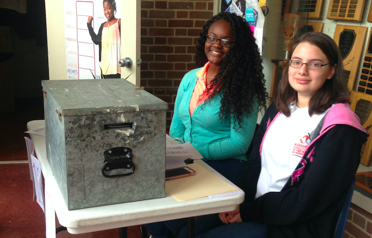 Daudreanna Baker (left) and Kaleigh Leiva (right) supervise the mock election booth.