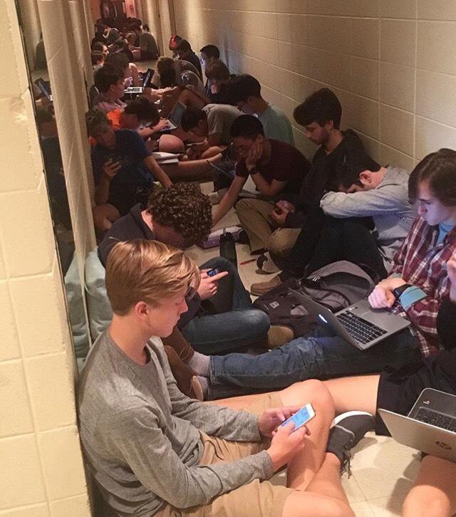 Students hunker down with homework while others check weather alerts.