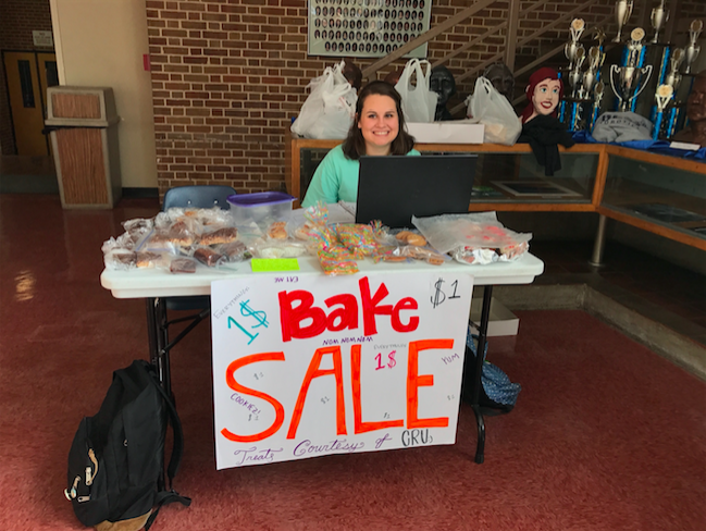 Kate Shelton sits at the bake sale table.
