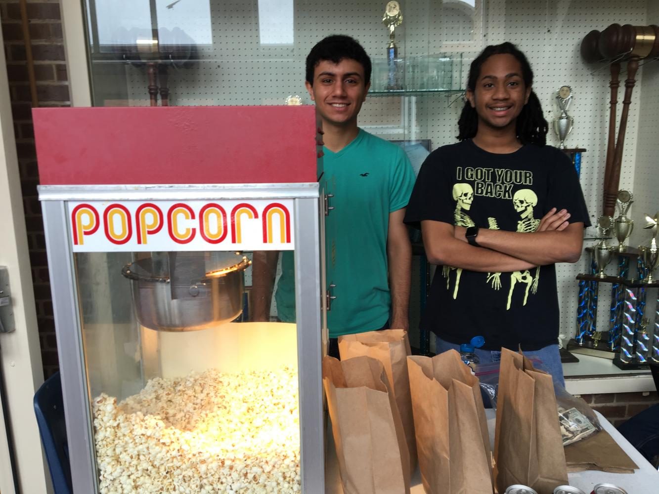 President Yousef Abu-Salah and Reyhan Grimes sell popcorn for the Forgotten Stories club.