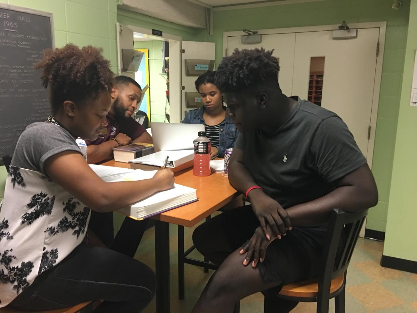 Resident assistant Chavis Ivory, helps junior Taniya Bland with her challenging homework on a Wednesday evening.
