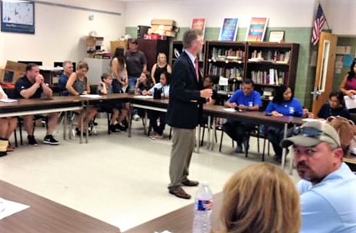 Dr. Thomas Easterling, English instructor, talks to eager parents in his classroom during Parents Day. 