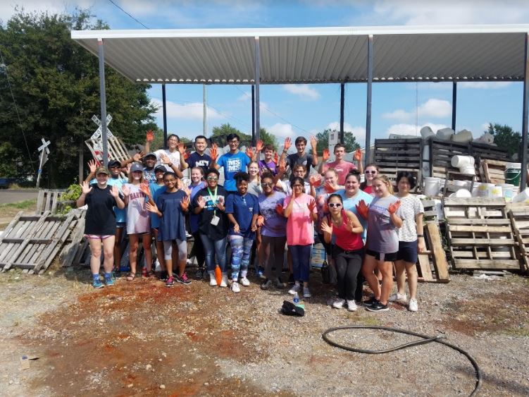 Students volunteered to clean water buckets for Operation Ukraine on Saturday