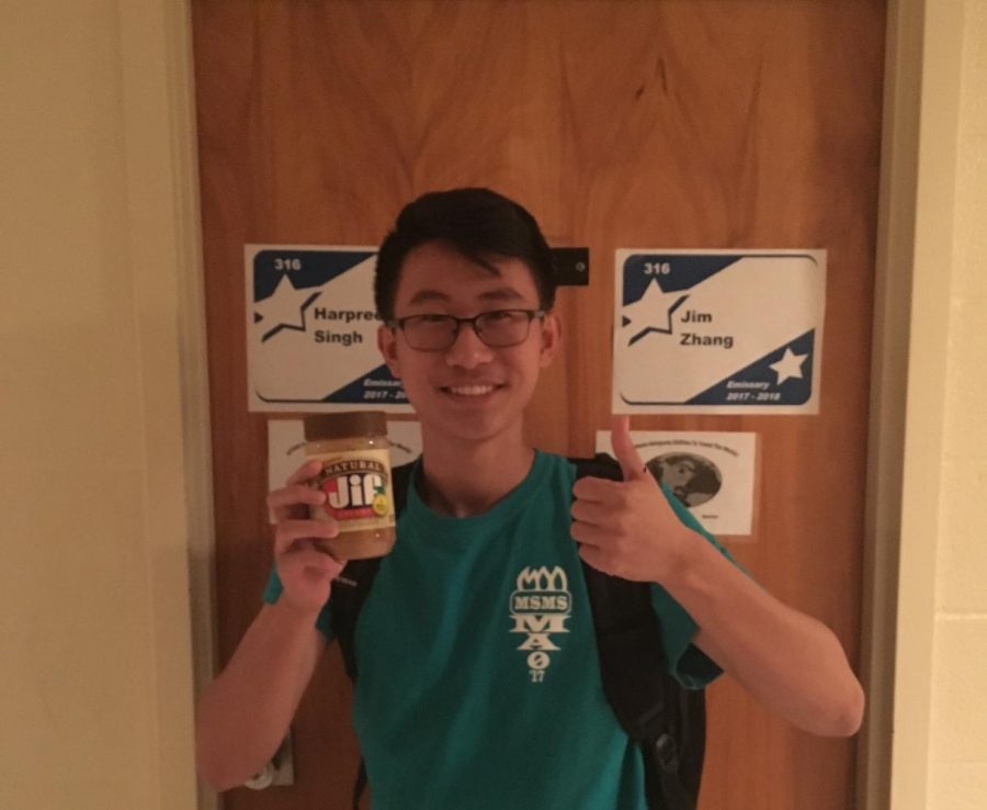Jim Zhang raises a jar of Jif in celebration of his title as National Merit Semifinalist.