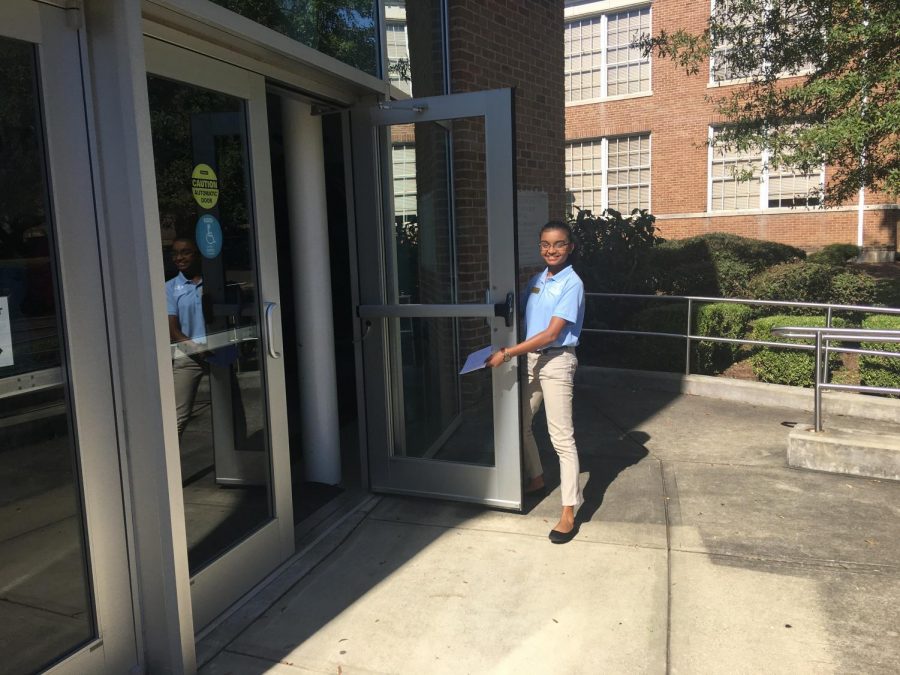 Emissary Mariat Thankachan welcomes students and parents as they enter into Nissan to start their Fall Preview Day experience.