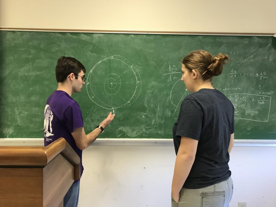 William Johnson and Leah Pettit plan up a storm on the chalkboard.