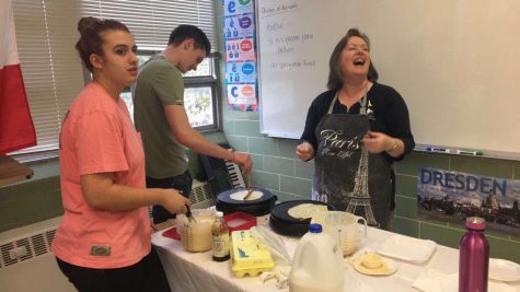Students making crepes during French Week.
