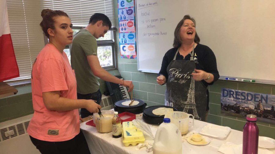 Students making crepes during French Week.