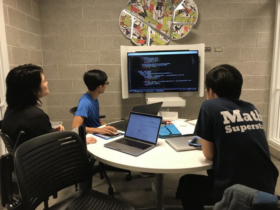 From left to right: Michelle Luo, Gary Nguyen, and Hamilton Wan study code in preparation for competition.