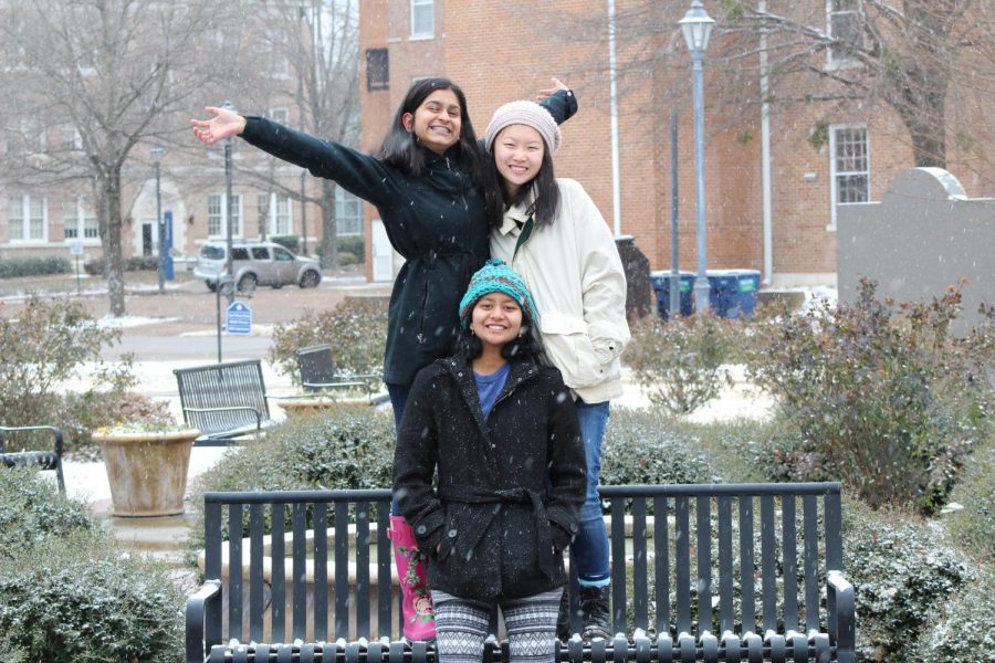 Sarena+Patel%2C+Likhitha+Polepalli%2C+and+Helen+Peng+enjoy+taking+photos+in+the+snow+in+front+of+Mary+Wilson.