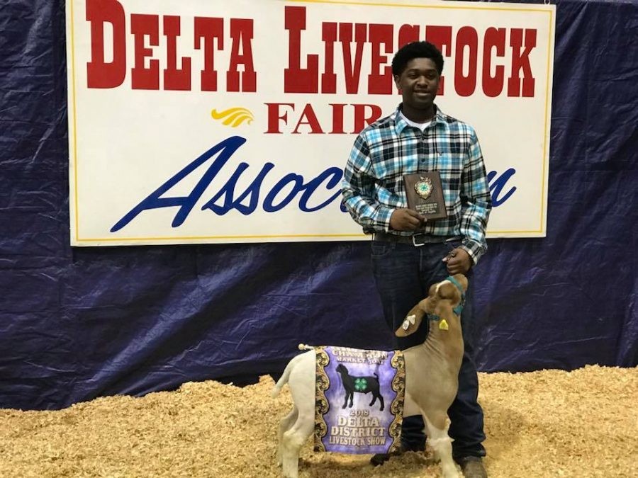 Tyler Branch stands proudly with his goat Cosmo.