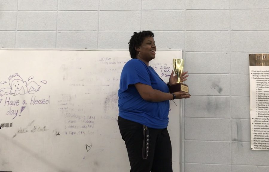 Mrs. LeAnn Alexander presents a trophy to the winning team of the first annual Great MSMS Boat Race.