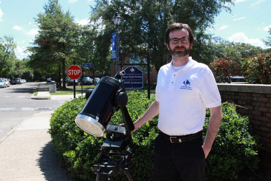Dr. Vaughan sets up his telescope in front of the Hooper Academic building to view sunspots.