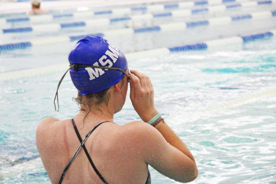 Senior+Breanna+Herd+prepares+to+swim+some+warm-up+laps.