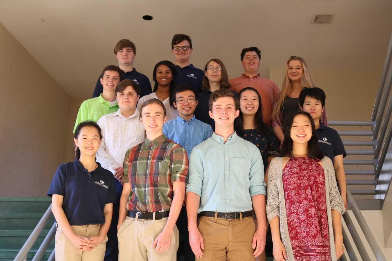 The fifteen National Merit Semifinalists pose for a photo at Trotter Convention Center .