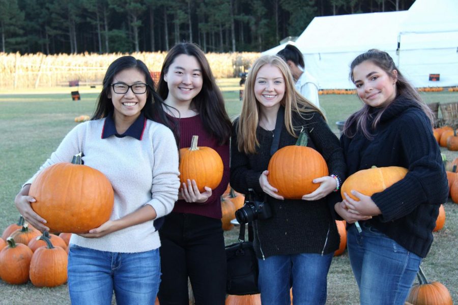 (Left to right) Gina Nguyen, Catherine Min, Taylor Willis, and Olivia Dosda smile with their chosen pumpkins.