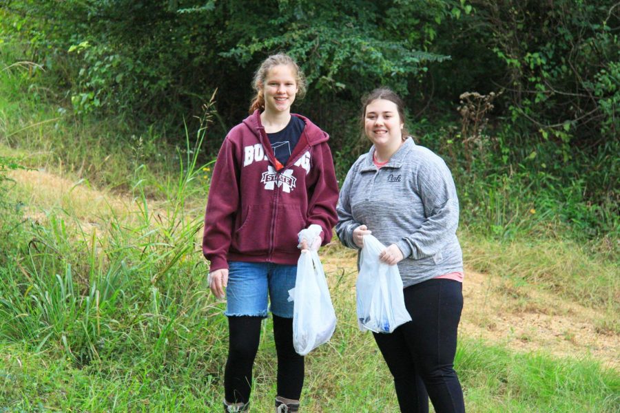 Ada Fulaghan and Ryley Fallon begin picking up trash.