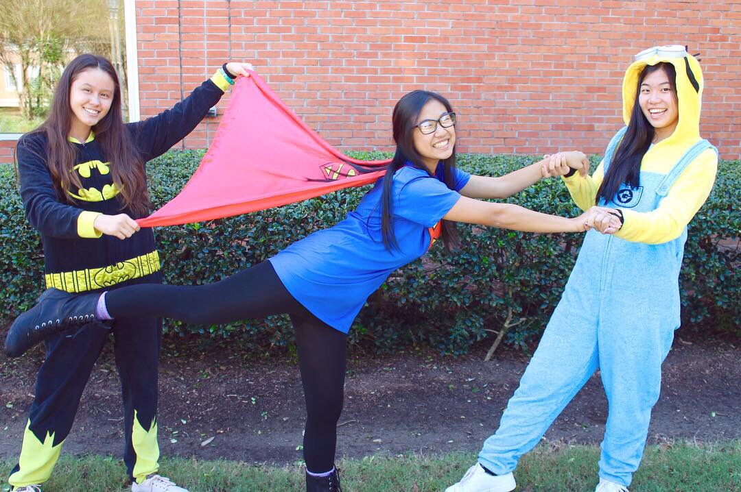 Juniors Linda Arnoldus, Gina Nguyen, and Catherine Li dress up as superheros for Breast Cancer Awareness week.