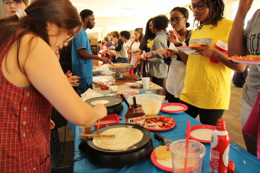 Students line up to try food from all over the world.