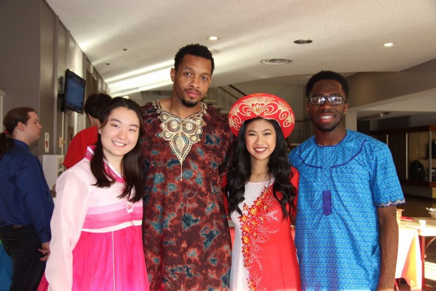 (Left to right) Catherine Min, RA Daniel Rogers, Gina Nguyen, and Morgan Emokpae dress in traditional clothing from various countries.