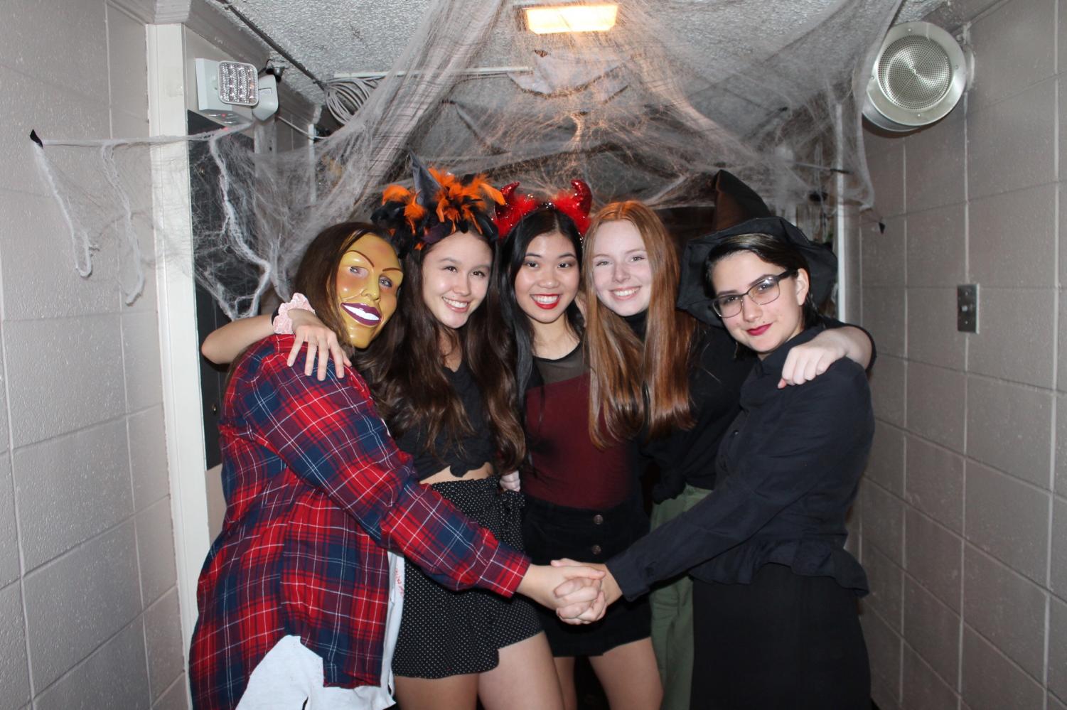 (Left to right) Camryn Mason, Linda Arnoldus, Catherine Li, Alden Wiygul, and Sarah Perry pose in front of their decorated hall.