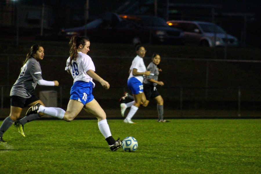 Madison Wypyski dribbles the ball away from the opposing team
