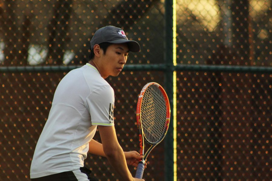 Junior Esmond Tsang concentrates as the ball is hit towards him.