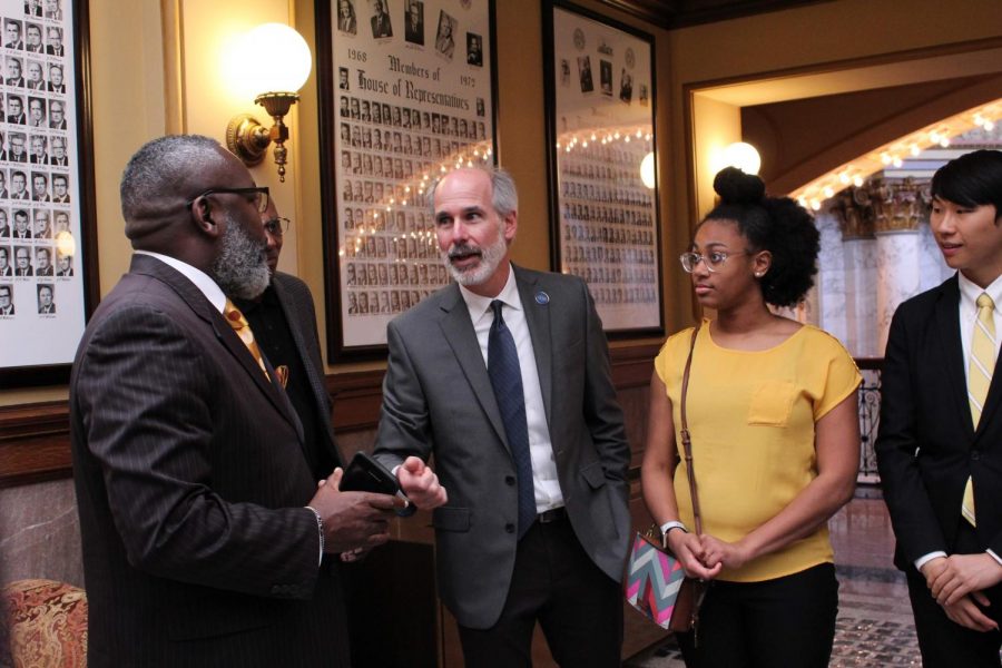 Chuck Yarborough is engaged in a conversation with State Senator.