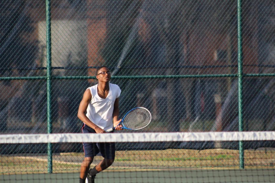 Ezra McWilliams prepares to return Trojan serve.