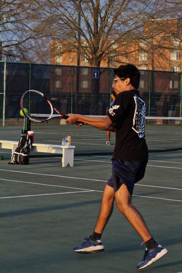Om Chimma deflects opposing doubles team's ball.