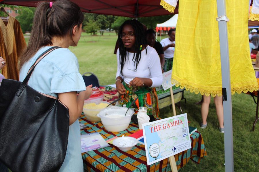 Aja Ceesay describes traditional foods from the Gambia to guests.