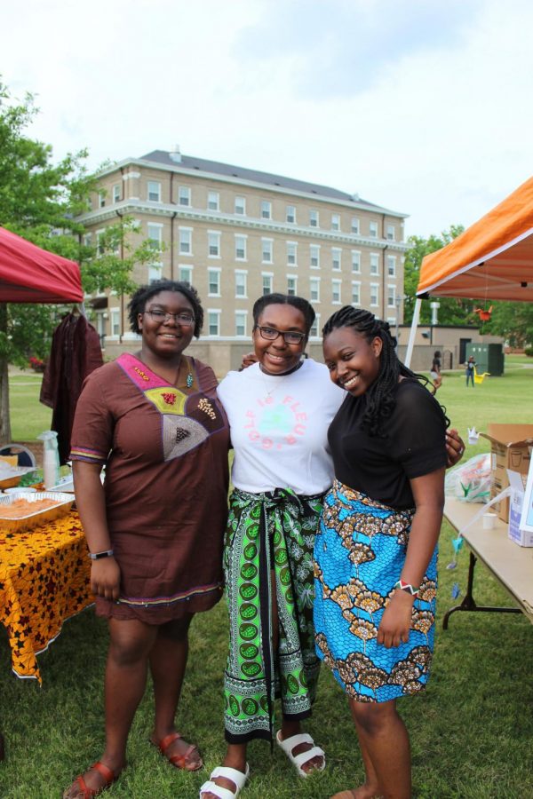 Binta Fadiga, Alicia Argrett, and Violet Jira pose in their traditional African clothing.