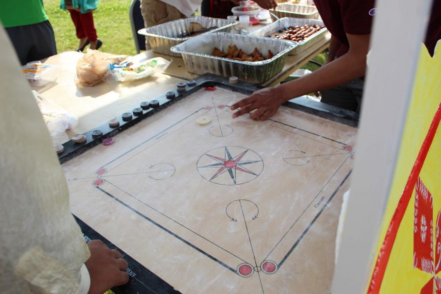 India's representatives explain the carrom board.