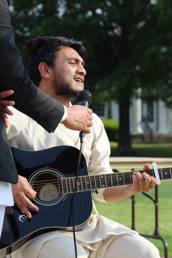 MUW student Biraj Adhikari plays his guitar and sings a Nepali song.