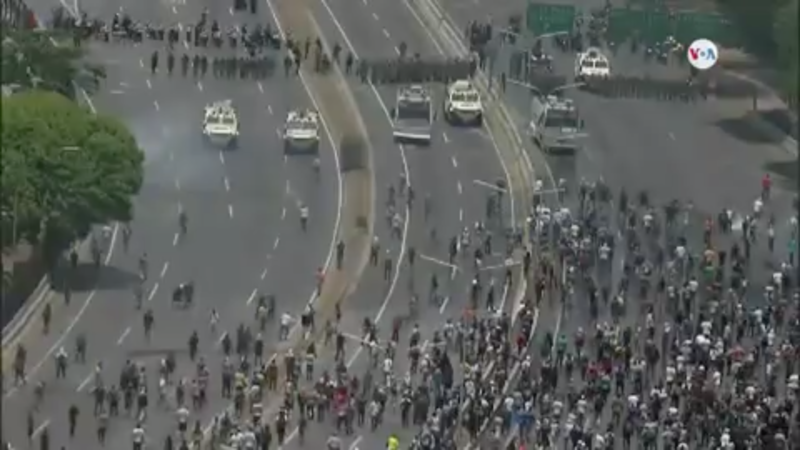 Pro-Maduro and pro-Guaidó protesters clash.