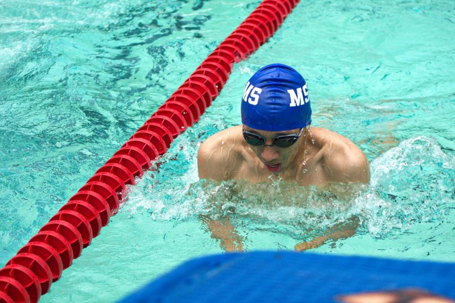 Junior Michael Lu finishes up the breaststroke. 