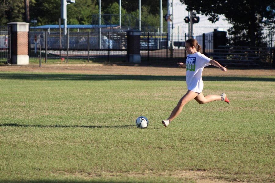 Junior Emily Berry practices kicking during an after school practice.