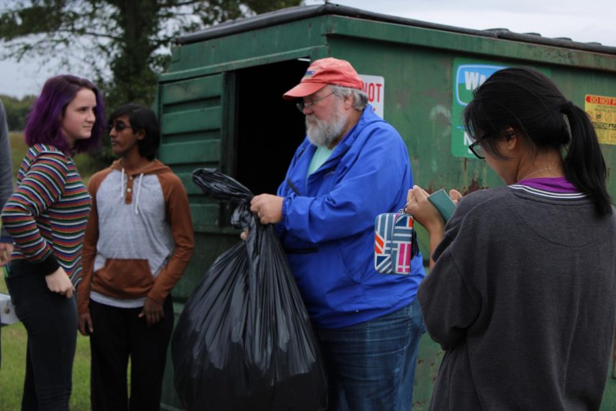 The team of Piper Britt, Raghav Nallani Chakravartula, Dr. Bill Odom and Gina Nguyen weigh and document each bag of trash as they place it in the trash bin.