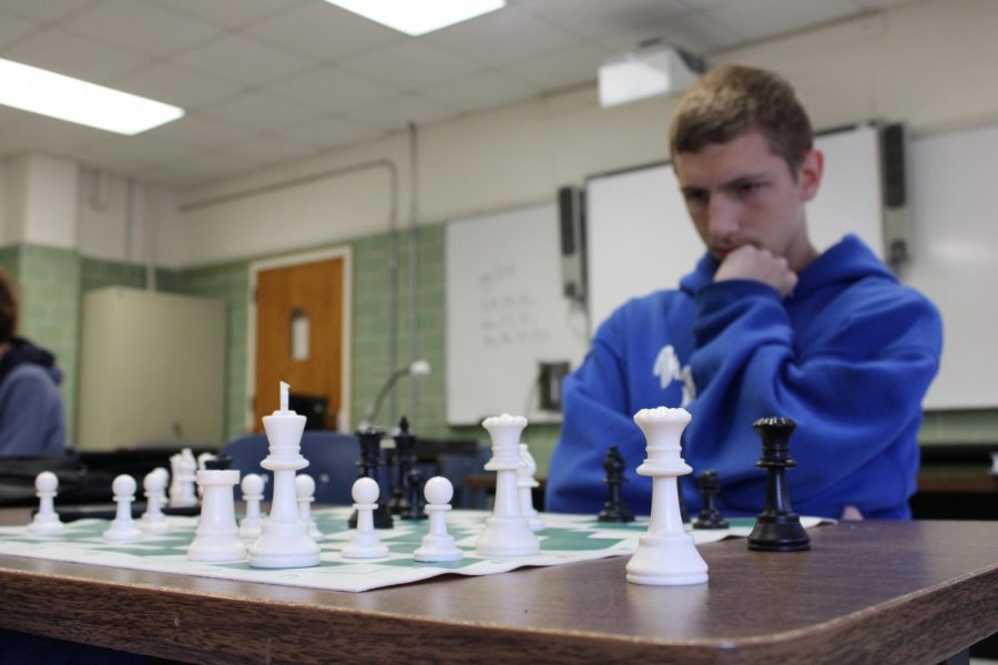 Matthew Dunn keeps his eyes locked on the board as his opponent takes his turn.